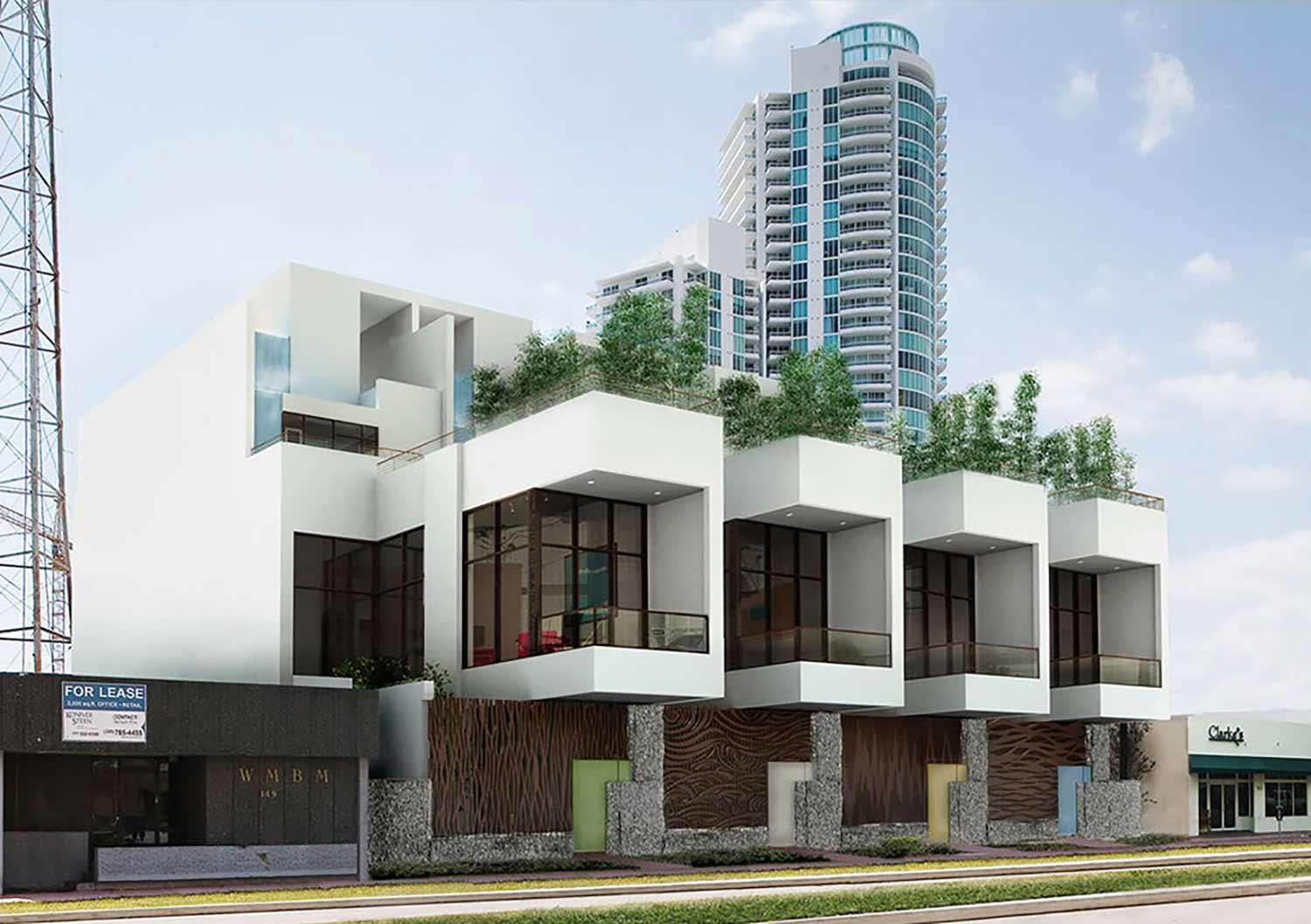 The project consists of four townhouses located on a broad landscaped boulevard in South Beach. The individual townhouses are composed of a series of horizontal, overlapping “drawers,” both enclosed and unenclosed, that create living areas of varying heights. These horizontal volumes are pinned together by a solid vertical element, the elevator, that sits near the center of each of the compositions. The landscaped ground level establishes the first of a series of horizontal planes that cap the shifting horizontal volumes. These are surfaced alternately in stone, natural ground cover, and wood decks, all with water features and variable amounts of vegetation.

The townhouses are differentiated by decorative attributes that identify each unit with one of the four elements: water, earth, fire, and air. These elements inform the individual designs of the cast metal fences, doors, and entry courts. Off-center pivoting main doors into the entry courts are built of smooth and rough-hewn stone, and translucent cast resin panels on a cast metal framework.